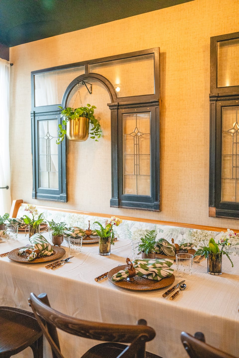 Friends celebrating at a Tonga Room shower — orchids and fern centerpieces on long table